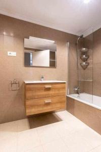 a bathroom with a sink and a shower and a mirror at Martin Deuna Etxea- Piso en zona residencial in Bermeo