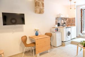 a kitchen with a table and chairs in a room at Dimora Lilina in Bari
