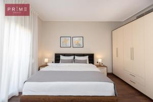 a bedroom with a large bed and white walls at Prime Select New Giza in Giza +153 photos