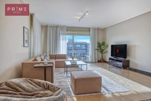 a living room with a couch and a tv at Prime Select New Giza in Giza