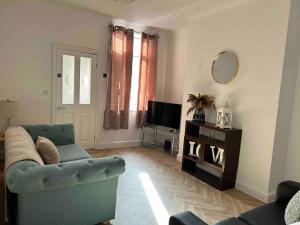 a living room with a couch and a television at 74 Ashby House 3 bed townhouse in Brumby