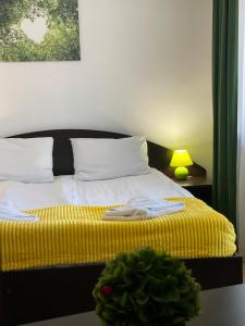 a bedroom with a bed with a yellow blanket at Grand Monastery Private Apartments in Pamporovo