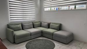 a living room with a couch and a window at APARTMENT KRISTINA in Dunajská Streda