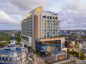 a large building with a clock on top of it at Platinum Hotel & Convention Hall Balikpapan in Balikpapan