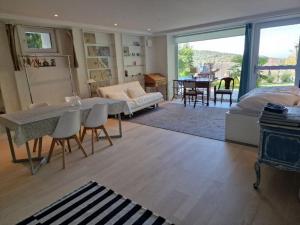 a living room with a bed and a dining room at Bellavista in Badenweiler