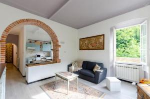 a living room with a couch and a table at 2 appartamenti totale 12 posti letto in Borgonovo +29 photos