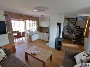 a living room with a couch and a table at Danube Escape with Jacuzzi, Pool & Spacious Yard by Destination GREEN Croatia in Bogaljevci