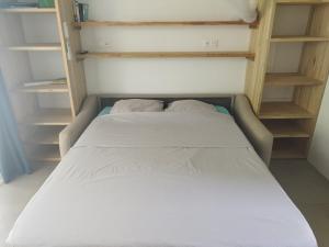 a bed with two pillows on it in a room at Studio Ti Bambou in La Trinité