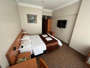 En eller flere senge i et værelse på Altinnal Hotel
