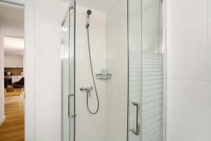 a shower in a bathroom with a glass door at Suite Deluxe Puerto Rico B in Puerto Rico de Gran Canaria +11 photos