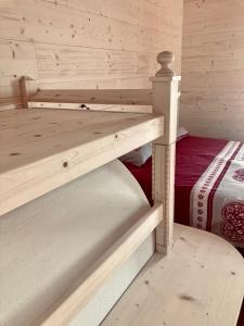 a room with two bunk beds in a cabin at Cèsa Sès da mont in Livinallongo del Col di Lana