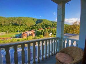 balcone con vista su una casa e sulle montagne di Panorama Dilijan Guest House a Dilijan