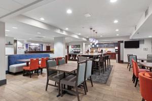 a restaurant with tables and chairs and a bar at Hampton Inn Rock Hill in Rock Hill