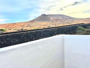 a train track with a mountain in the background at Apartamento Guanapay by Vulcano Homes in Teguise