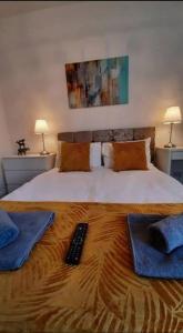 a bedroom with a bed with a remote control on it at Finsbury Workstays UK in Middlesbrough