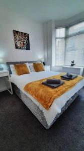 a bedroom with a large bed with two towels on it at Finsbury Workstays UK in Middlesbrough