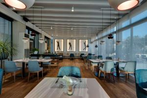 a restaurant with tables and chairs and windows at Barceló Costa Ballena Golf & Spa in Costa Ballena