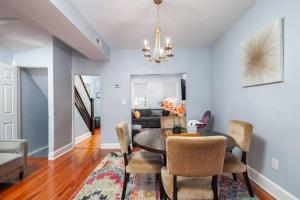 a dining room with a table and chairs and a couch at Stylish Retreat- Metro in Vibrant Washington DC! in Washington, D.C.