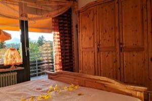 a bedroom with a bed and a large window at Ferienwohnung am Weissensee mit Pool,Sauna in Füssen