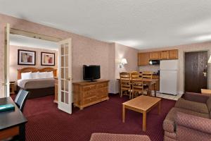 a hotel room with a bed and a living room at Quality Inn & Suites in Craig