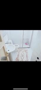a white bathroom with a sink and a toilet at Eto konaklama in Istanbul