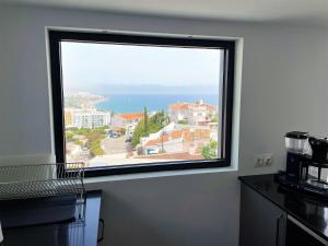 a window in a kitchen with a view of the ocean at Fantastic view near the beach in Nerja in Nerja