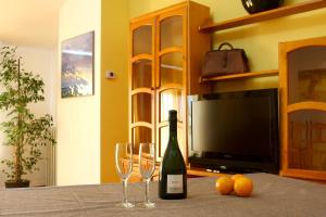 a bottle of wine and two wine glasses on a table at Doña Ruidera in Ruidera