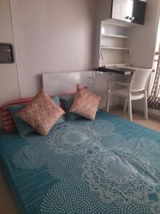 uma cama com almofadas num quarto em Tiger Den stylish studio Apartment em Chengalpattu