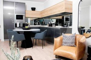 a kitchen with a table and chairs in a room at Epic Getaway in Waterfall in Midrand