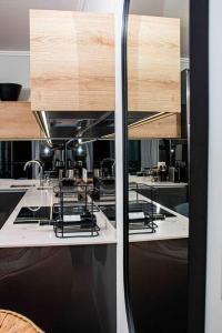 a kitchen with a counter top with a mirror at Epic Getaway in Waterfall in Midrand +9 photos