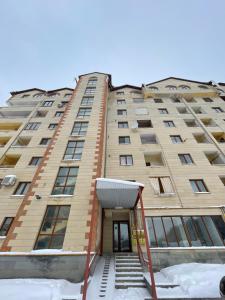 a tall building with a staircase in front of it at Daily Rental Apartment 12 in Tsaghkadzor
