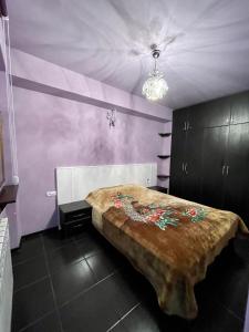 a bedroom with a large bed with a wooden table at Daily Rental Apartment 12 in Tsaghkadzor