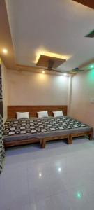 a large bed in a room in at Anant home stay in Ujjain