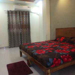 a bedroom with a bed in a room with curtains at Anant home stay in Ujjain