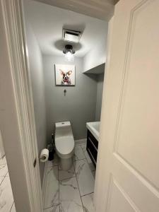 a small bathroom with a toilet and a sink at Downtown Delight in Heart of DC’s Bustling Streets in Washington, D.C.