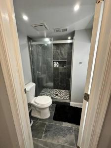 a bathroom with a toilet and a shower at Downtown Delight in Heart of DC’s Bustling Streets in Washington