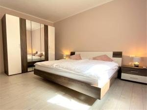 a bedroom with a large bed and a mirror at Villa Maduna 1 in Kaštel