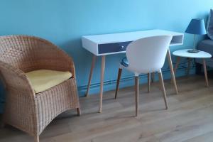 a desk and chair next to a table and a chair at Chez Magali in Rouen