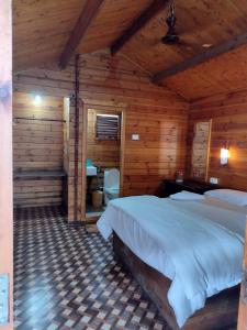 a bedroom with a bed in a wooden cabin at Roundcube Beach Bungalows Patnem in Patnem