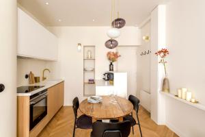 een keuken en eetkamer met een tafel en stoelen bij Lune Montorgueil in Parijs
