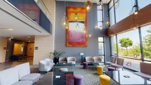 a lobby with chairs and a painting on the wall at Best Western Premier Sofia Airport Hotel in Sofia