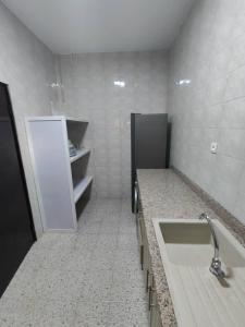 a bathroom with a tub and a sink in it at Residence Galaxy Togo in Lomé