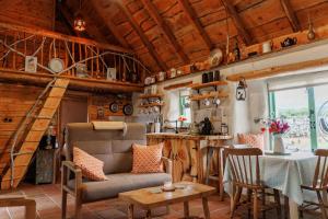 a living room with a staircase in a tiny house at Patsys Cottage 415 in Rusheeny