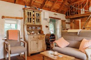 a living room with a couch and chairs and a table at Patsys Cottage 415 in Rusheeny