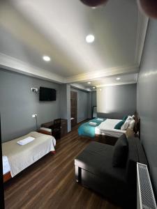 a hotel room with two beds and a couch at Mestia 4 season in Mestia