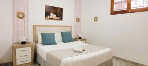 a bedroom with two beds with blue pillows at Sabbia Suites Pleamar in Puerto del Carmen