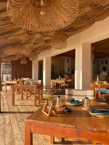 a dining room with wooden tables and chairs at Hotel Apollo in Hikkaduwa