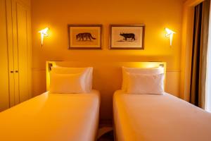 Postel nebo postele na pokoji v ubytování Art Legacy Hotel Baixa-Chiado