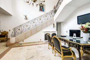 a dining room with a table and chairs and a staircase at La demeure d'Iris in Bougival