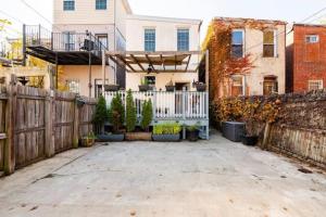 a backyard with a wooden fence and a gate at Persian Paradise Luxury with Private Parking in Washington, D.C.